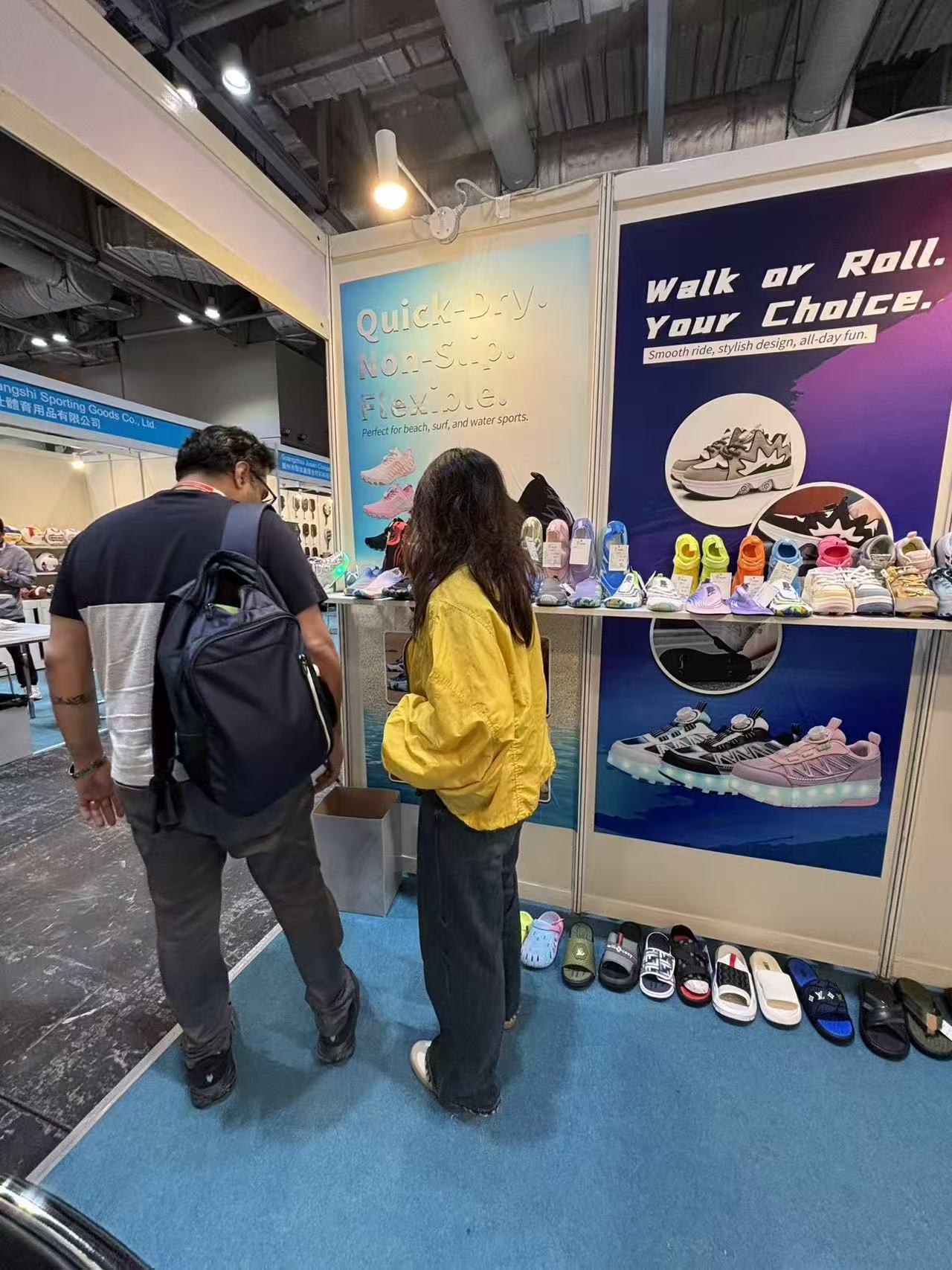 Visitors reviewing shoe colors and constructions at a trade-show display